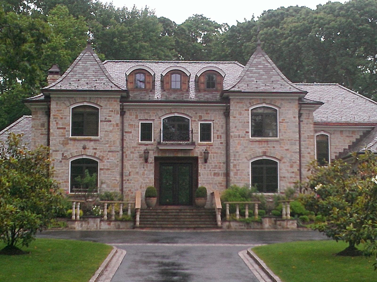 Slate-style estate roof on a luxury stone French chateau home on Long Island